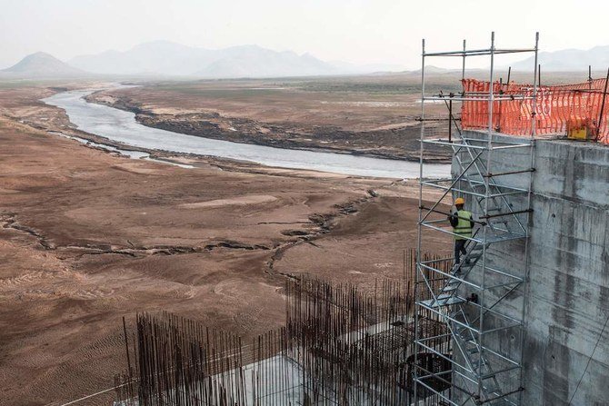 A worker goes down a construction ladder at the Grand Ethiopian Renaissance Dam (GERD), near Guba, Ethiopia, December 26, 2019. (AFP)