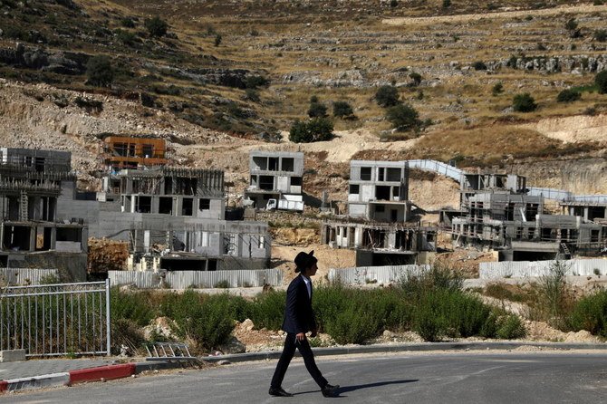 A Jewish settler walks past Israeli settlement construction sites around Givat Zeev and Ramat Givat Zeev in the Israeli-occupied West Bank, near Jerusalem. (File/Reuters)