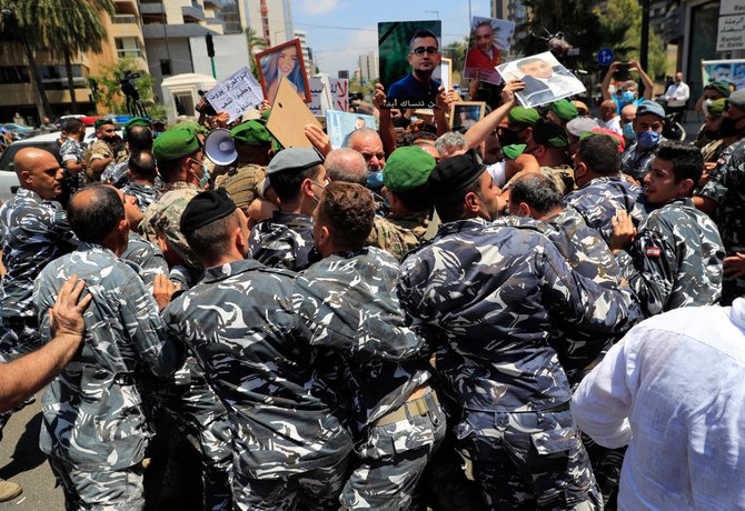 Lebanon parliament speaker Nabih Berri's security push back families of the victims of last year's Beirut seaport blast as they protest in Beirut on July 9, 2021. (AP)