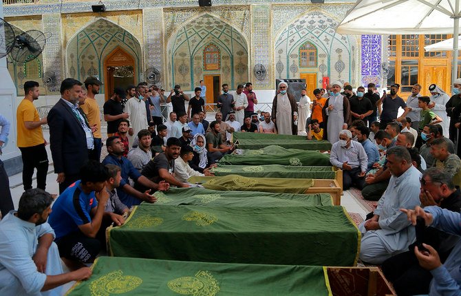 Mourners in Najaf prepare to bury victimsof a fire that swept through a coronavirus ward in the southern city of Nasiryah. (AP)