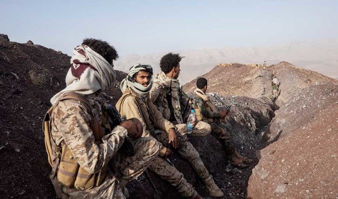 Yemeni fighters stand at a distance from the frontline after clashes with Houthi rebels on the Kassara frontline near Marib, Yemen. (AP file photo)