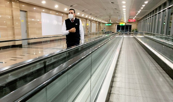 An Egyptian flight crew member wears a protective mask following an outbreak of the coronavirus disease (COVID-19) at Cairo International Airport in Cairo, Egypt. (REUTERS file photo)