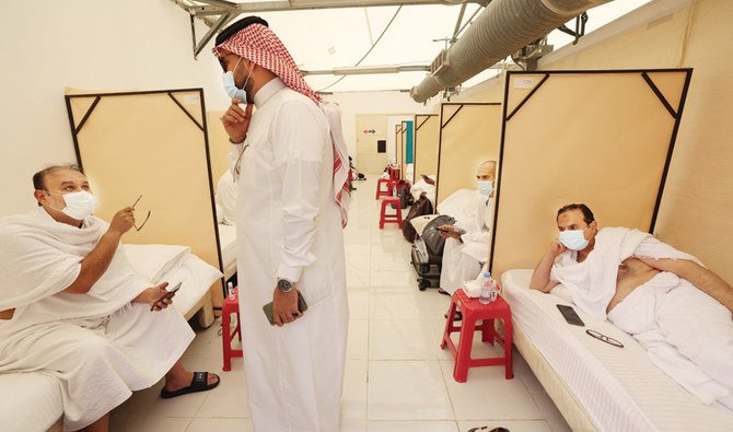 Hajj pilgrims rest at their camps in the tent city of Mina on Sunday. (AFP)