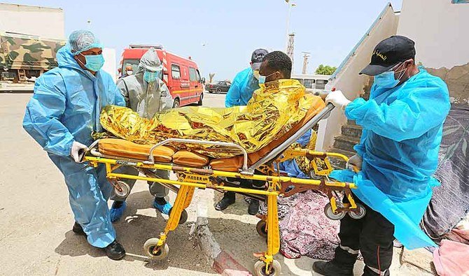 Medics transport a migrant at the port of El-Ketef in southern Tunisia near the border with Libya. The migrant was rescued by Tunisia’s national guard. (File/AFP)