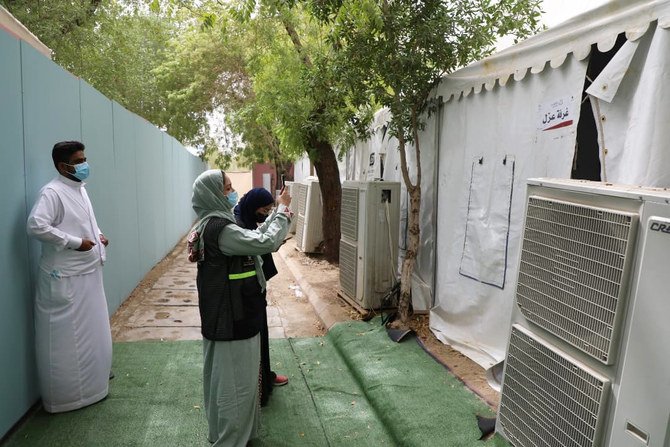 A member of the Hajj ministry inspection team takes pictures of pilgrims' tents in Mina on Monday. (Supplied)