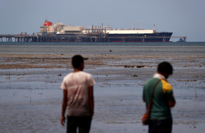 An LNG carrier is docked at marine facility of ExxonMobil in Port Moresby. Exxon shareholders elected two new climate-conscious board members. (Reuters)