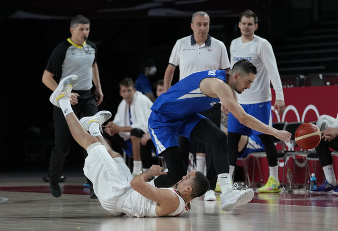 Iran's Pujan Jalalpoor falls as Czech Republic's Tomas Satoransky reaches towards the ball during the men's basketball game opener in Tokyo on July 25, 2021. (AP Photo/Eric Gay)