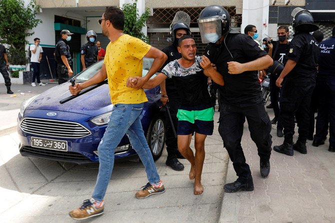Tunisian police detain a demonstrator in Tunis on July 25, 2021. (REUTERS/Zoubeir Souissi)