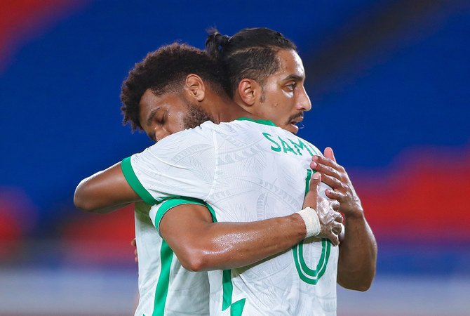 Saudi football players Salem Al-Dossary, left, and Sami Al-Najei console each other after the loss to Germany. (Twitter: @saudiolympic)