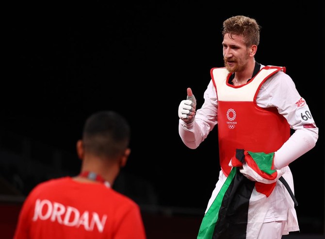 Saleh Elsharabaty of Jordan celebrates winning silver with the Jordanian flag. (Reuters)