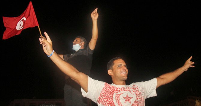 Thousands celebrated on the streets on Monday after Saied dismissed the government. (AP)