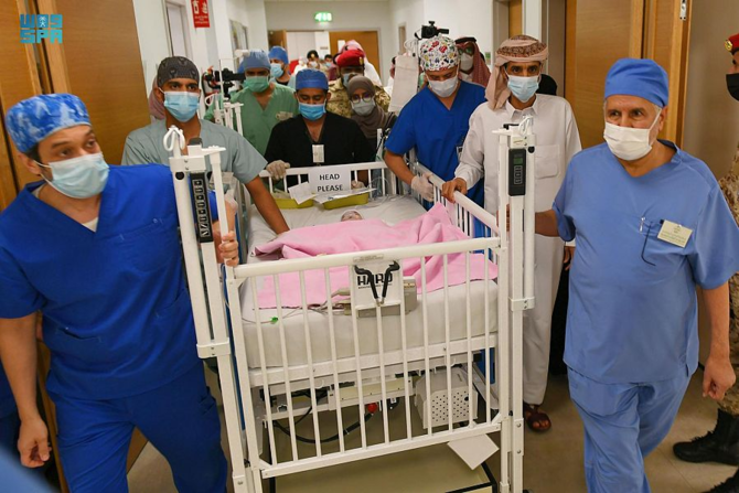 Aisha is led away from the operating theatre after her successful procedure. (SPA)