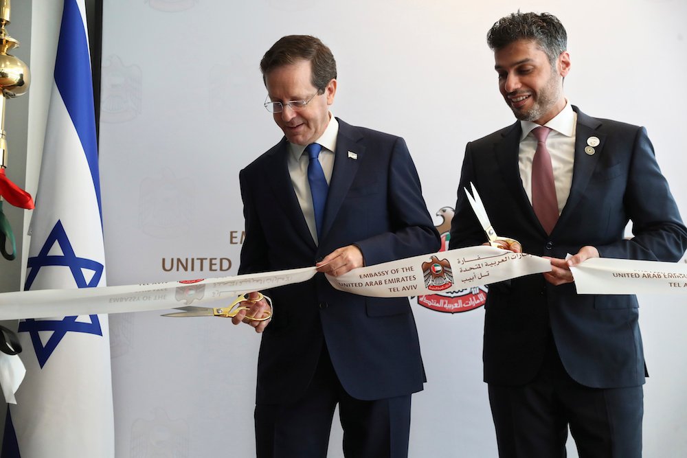 Israel's President Isaac Herzog cuts a ribbon with UAE Ambassador to Israel Mohamed Al Khaja. (AP)