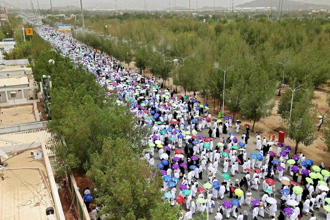 Muslim pilgrims gather to perform noon and afternoon prayers at Namira Mosque in Mount Arafat, southeast of the Saudi holy city of Makkah on July 19, 2021. (AFP)