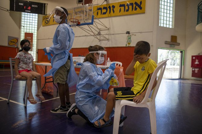 Israel's prime minister is urging the country's youth to get vaccinated as coronavirus case numbers have crept up in recent days. (AP)