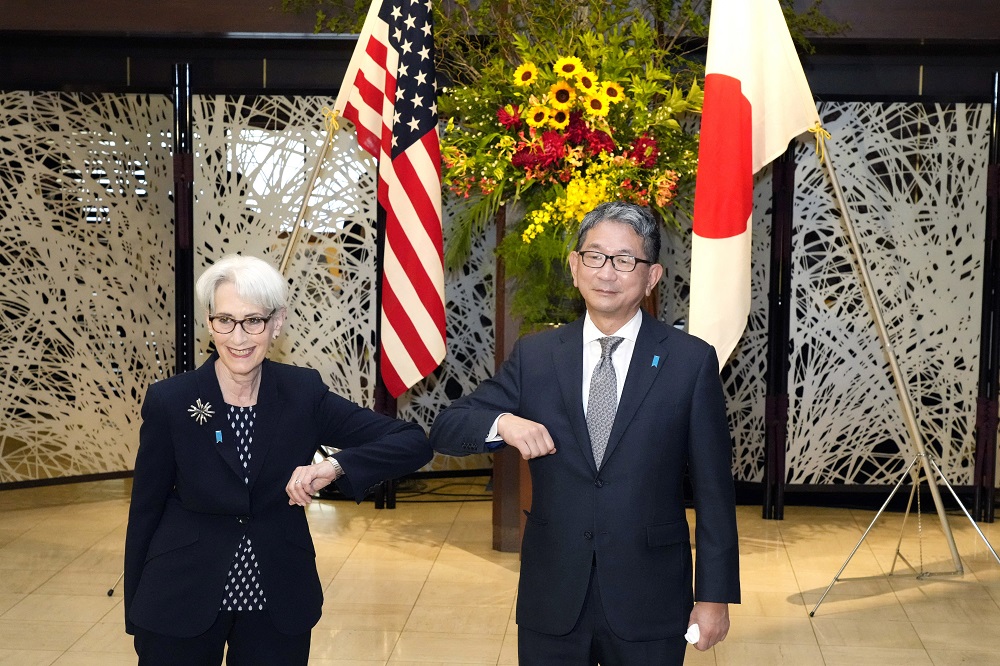 US Deputy Secretary of State Wendy Sherman (left) elbow bumps with Japan's Vice Minister for Foreign Affairs Takeo Mori (right) prior to their meeting at the Iikura Guesthouse in Tokyo on July 20, 2021. (AFP)