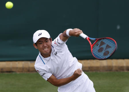 Japan's Yoshihito Nishioka serves to John Isner of the United States during the men's singles first round match on day three of the Wimbledon Tennis Championships in London, Wednesday, June 30, 2021. (AP)