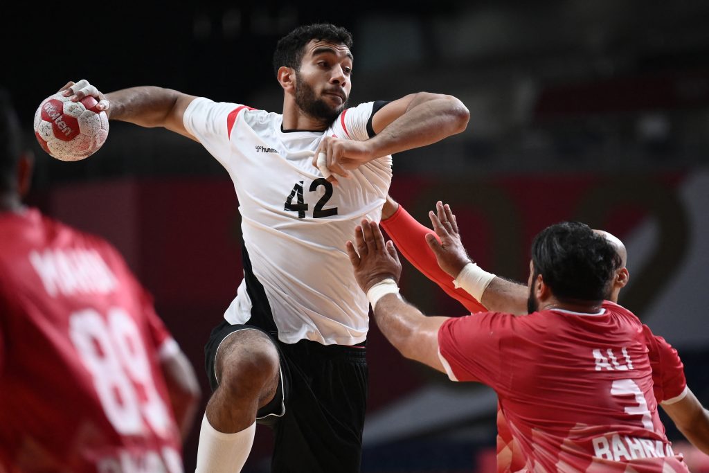 Egypt's left back Hassan Walid Kaddah is challenged during the men's preliminary round group B handball match between Egypt and Bahrain of the Tokyo 2020 Olympic Games at the Yoyogi National Stadium in Tokyo on August 1, 2021. (AFP)