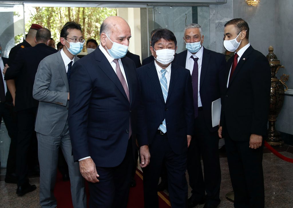 Japanese Foreign Minister Toshimitsu Motegi, third from right, arrives to meet his Iraqi counterpart Fouad Hussein, fourth from right, in Baghdad, Iraq, Aug. 21, 2021. (File photo/AP)