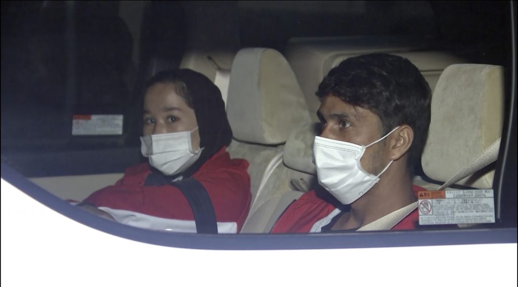 In this image made from a video, Afghan athletes Zakia Khudadadi, left, and Hossain Rasouli arrive at Haneda airport in Tokyo Saturday, Aug. 28, 2021. They have arrived in Tokyo, via what's been described as a harrowing journey from Kabul to Paris, to compete in the Paralympics. (TBS via AP)