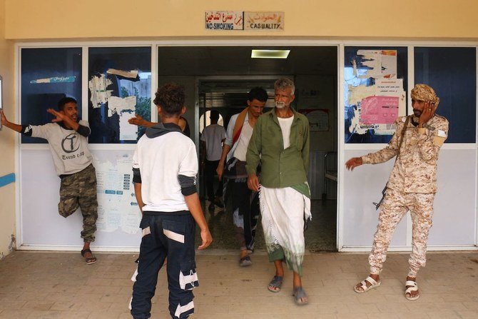 Relatives wait for news on casualties of strikes on Al-Anad air base at the Ibn Khaldun hospital in Yemen's government-held southern province of Lahij, on August 29, 2021. (AFP)