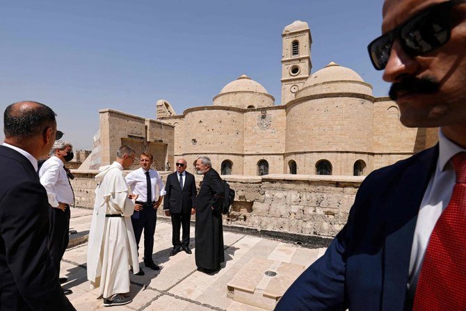 French President Emmanuel Macron (C) tours the Our Lady of the Hour Church in Iraq's second city of Mosul, in the northern Nineveh province, on August 29, 2021. (AFP)