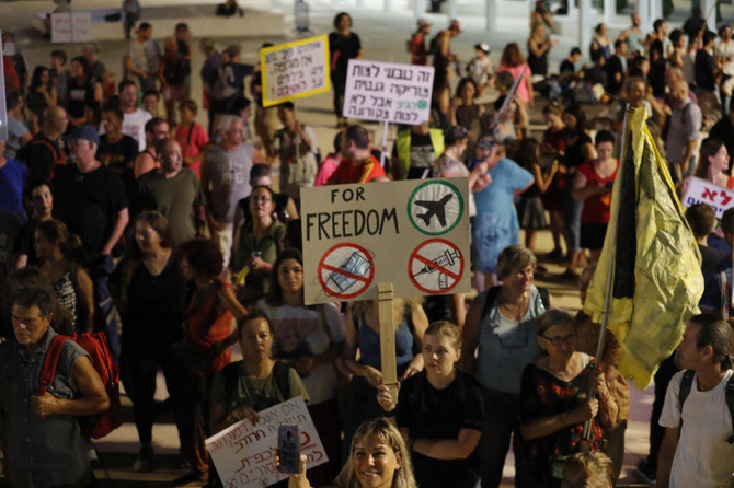 Israelis lift placards at a rally denouncing the government’s renewed restrictions to combat COVID-19, in the central coastal city of Tel Aviv. (File/AFP)