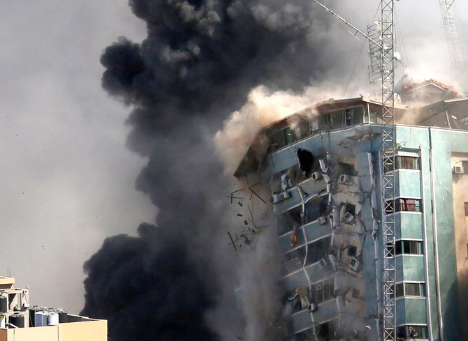 The Al-Jalaa building housing the offices of The Associated Press and other media and home to dozens of families, collapses after it was hit by an Israeli airstrike, in Gaza City. (AP/File)