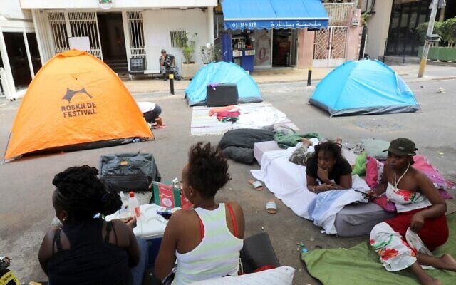 Kenyan domestic workers camp on August 20, 2020, outside the Kenyan consulate in Beirut after losing their jobs, due to the economic crisis, to demand repatriation back home. (AFP)