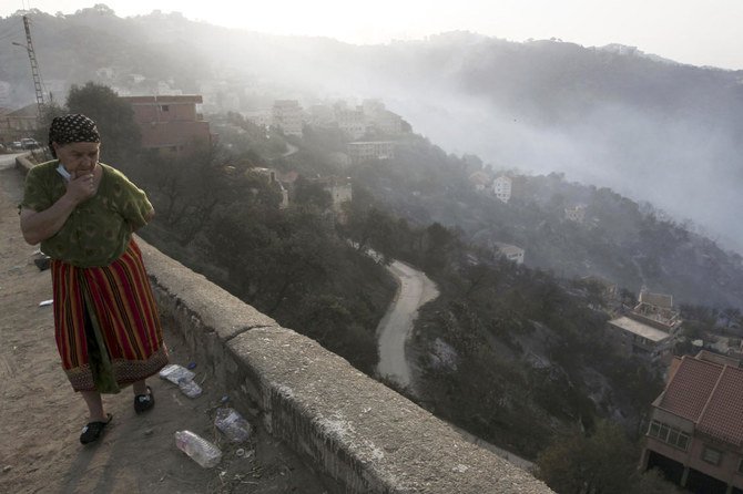 A woman reacts after wildfires in the village of Larbaa Nath Irathen, neat Tizi Ouzou, 100 kilometers east of Algiers, Wednesday, Aug.11, 2021. (AP)