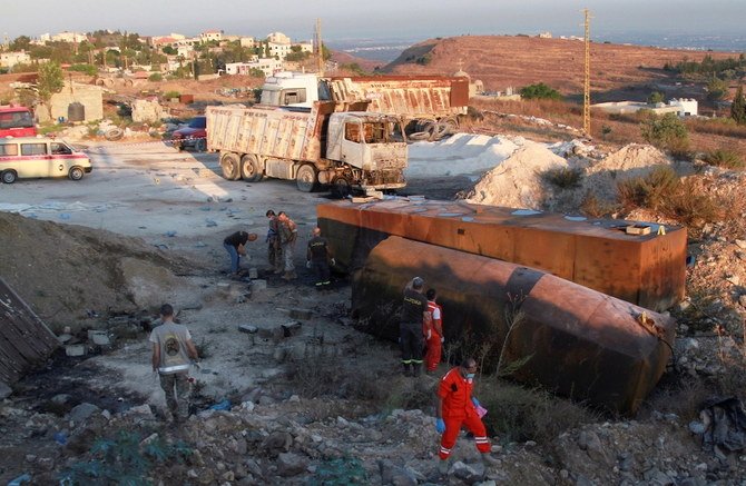 Lebanese army soldiers, civil defense members and rescuers at the site of a fuel tanker explosion in Akkar in northern Lebanon on August 15, 2021. (Reuters)