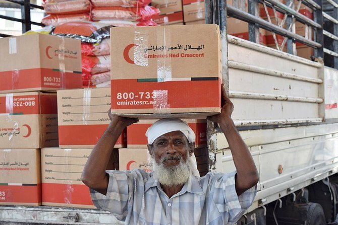 An elderly Yemeni man receives food parcels provided by the Emirati branch of the Red Crescent, in the southern port city of Aden. (File/Saleh Al-Obeidi/AFP via Getty Images)