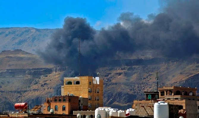 Smoke billows following an Arab coalition airstrike in the Yemeni capital Sanaa, November 27, 2020. (AFP)