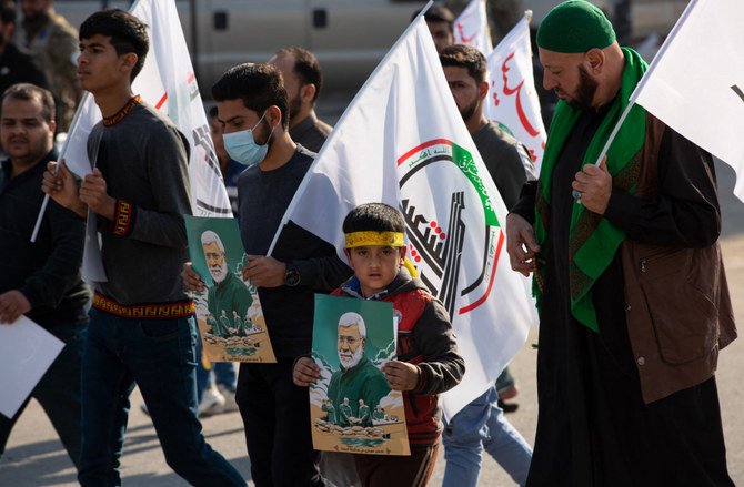 Iraqis take part in an event celebrating the inauguration of a street named after the late Iraqi commander Abu Mahdi al-Muhandis in the southern city of Basra on January 8, 2021. (AFP)
