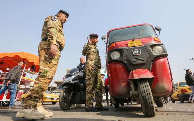 Iraqi police man search a vehicle at a checkpoint on the entrance of Baghdad's Tahrir Square. (AFP file photo)