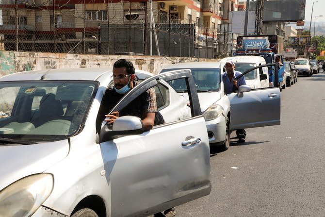 People push their cars due to a lack of fuel, near a gas station in Dora, Lebanon, Aug. 17, 2021. (Reuters)