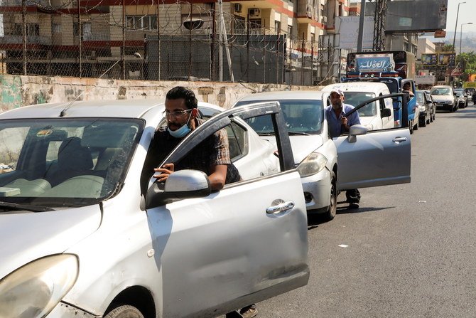 People push their cars due to a lack of fuel, near a gas station in Dora, Lebanon, Aug. 17, 2021. (Reuters)