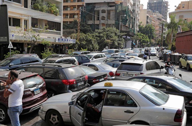 Lebanon has been experiencing a shortage in fuel supplies. Above, residents wait in a queue outside a closed petrol station in Beirut’s Hamra district on Aug. 20, 2021. (AFP)