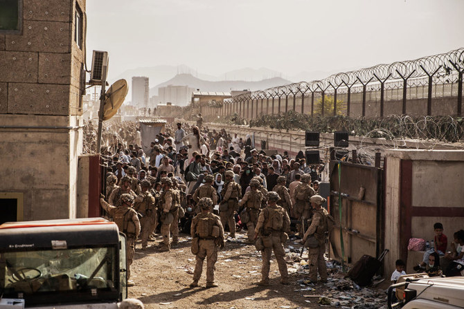 US Marines provide assistance during an evacuation at Hamid Karzai International Airport, Kabul, Afghanistan, Saturday, Aug. 21, 2021. (AP)