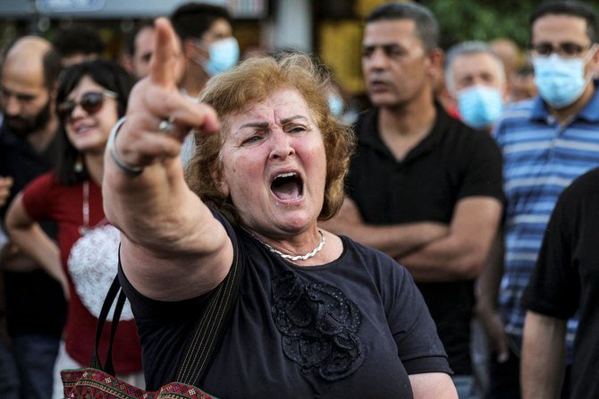 A woman chants slogans as protesters rally in Ramallah, occupied West Bank on Wednesday for a demonstration denouncing the Palestinian Authority in the aftermath activist Nizar Banat’s death. (AFP)