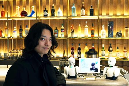 In this picture taken on August 17, 2021, Kentaro Yoshifuji, an entrepreneur who co-founded the robotics company Ory Laboratory, poses at the Dawn Cafe in Tokyo. (AFP)