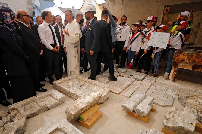 French President Emmanuel Macron (C) tours the Our Lady of the Hour Church in Iraq's second city of Mosul, in the northern Nineveh province, on August 29, 2021. (AFP)