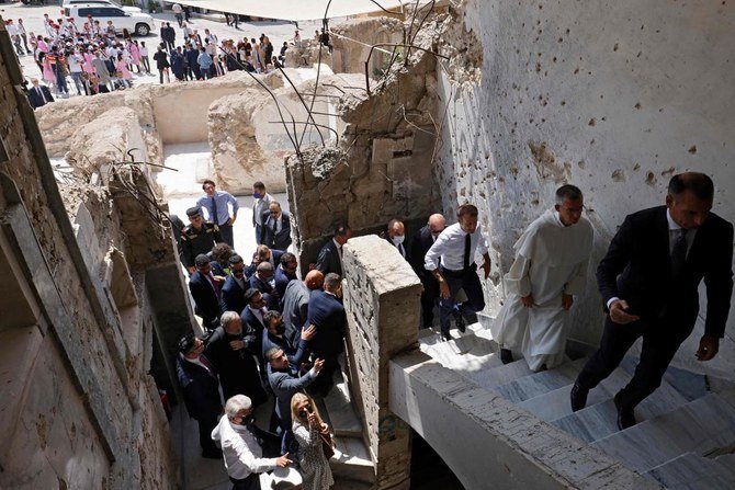 French President Emmanuel Macron (C) tours the Our Lady of the Hour Church in Iraq's second city of Mosul, in the northern Nineveh province, on August 29, 2021. (AFP)