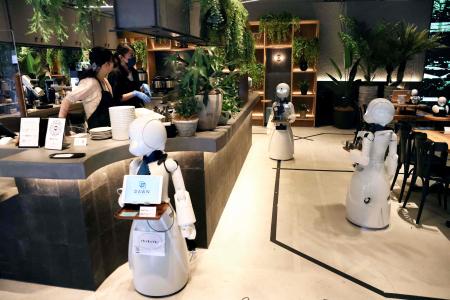This picture taken on August 17, 2021 shows humanoid robots which can deliver drinks to customers at the Dawn Cafe in Tokyo. (AFP)