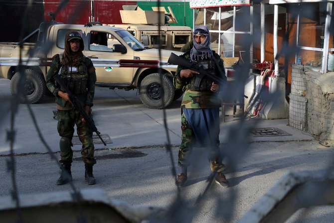 Taliban fighters stand guard at a checkpoint near the gate of Hamid Karzai international Airport in Kabul, Afghanistan, Saturday, Aug. 28, 2021. (AP)