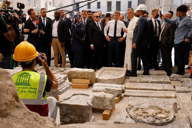 French President Emmanuel Macron (C) tours the Our Lady of the Hour Church in Iraq's second city of Mosul, in the northern Nineveh province, on August 29, 2021. (AFP)