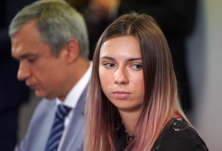 Belarusian sprinter Krystsina Tsimanouskaya, who left the Olympic Games in Tokyo and seeks asylum in Poland, and Belarusian opposition politician Pavel Latushka attend a news conference in Warsaw, Poland August 5, 2021. (Reuters)