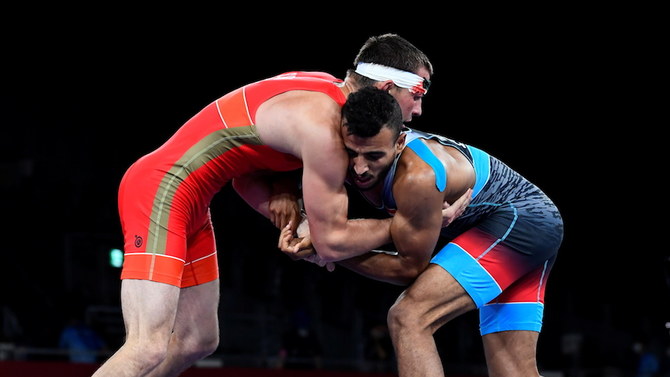 Artem Surkov of the Russian Olympic Committee and Mohamed Ibrahim Elsayed, right, of Egypt in the Greco-Roman 67kg bronze medal match, Makuhari Messe Hall A, Chiba, Japan, Aug. 4, 2021. (Reuters)