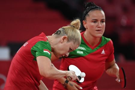 Hungary's Maria Fazekas (left) plays a shot during their women's team round of 16 table tennis match at the Tokyo Metropolitan Gymnasium during the Tokyo 2020 Olympic Games in Tokyo on August 1, 2021. (AFP)