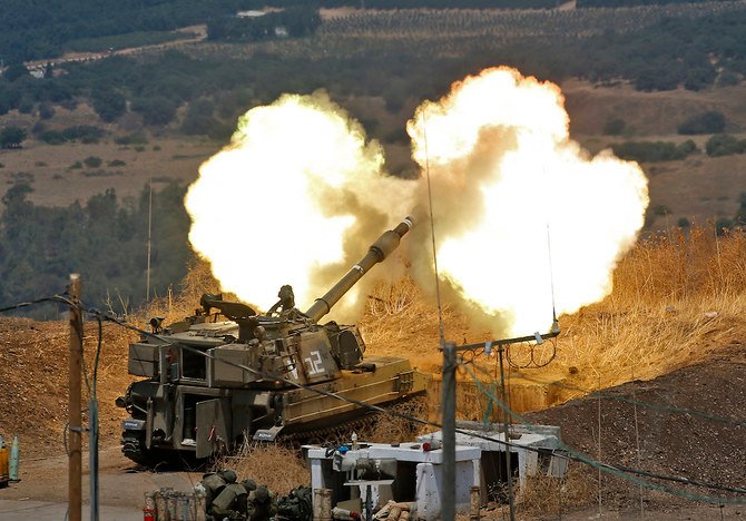 Israeli self-propelled howitzers fire towards Lebanon from a position near the northern Israeli town of Kiryat Shmona following rocket fire from the Lebanese side of the border, on August 6, 2021. (AFP)